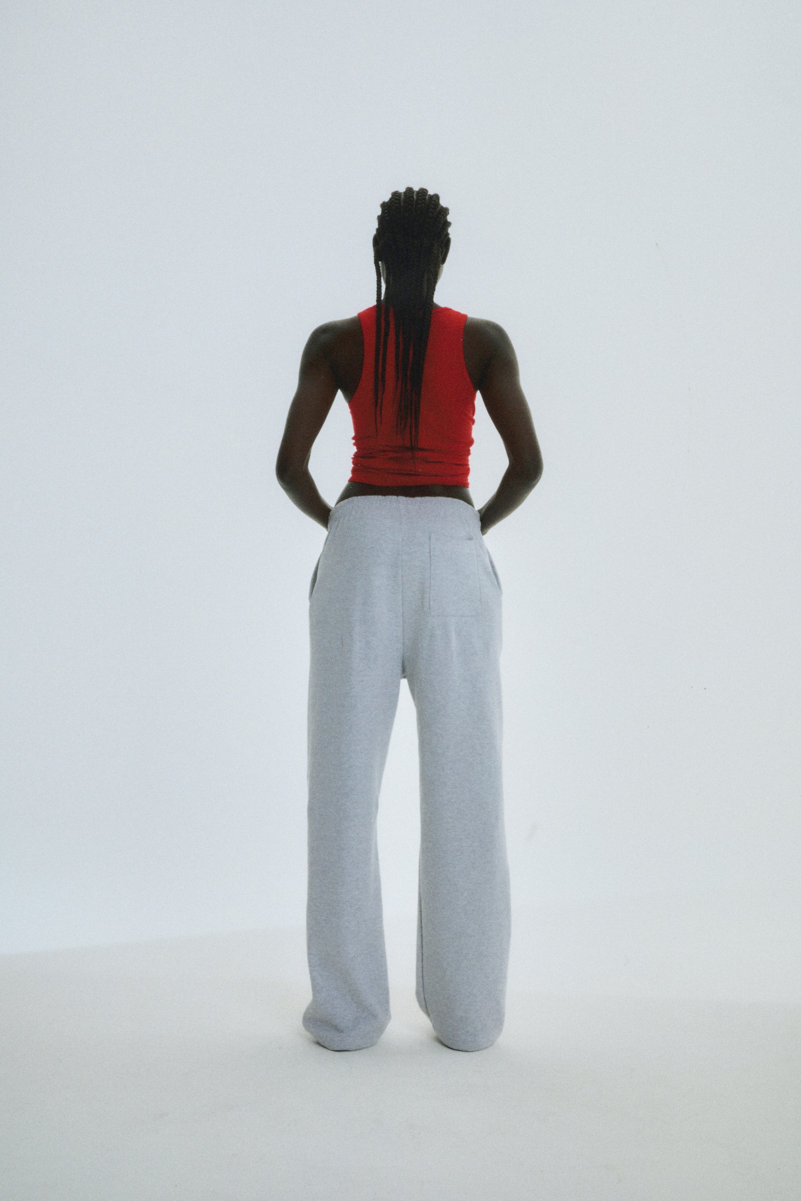 Model from behind wearing light grey wide-leg sweatpants with a drawstring waist.