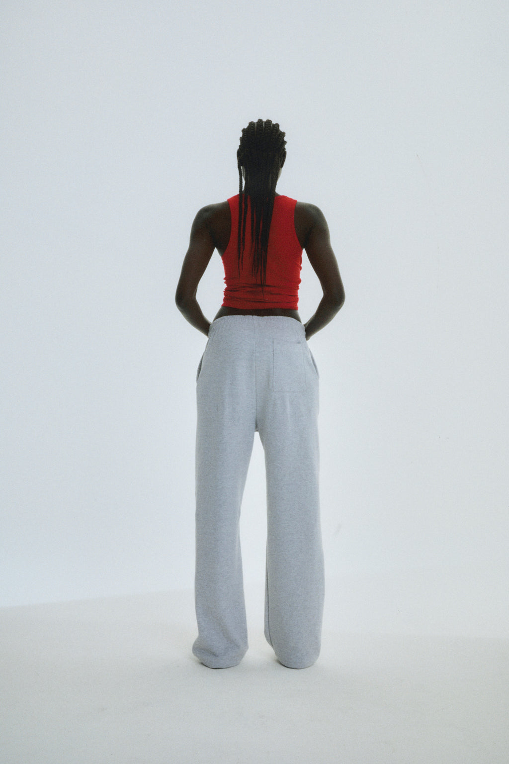 Model from behind wearing light grey wide-leg sweatpants with a drawstring waist.