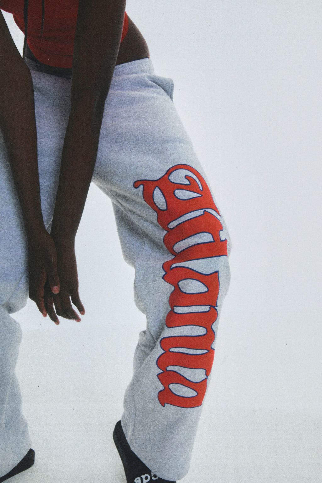 Grey cotton fleece wide-leg sweatpants with "Atlanta" script and scattered stars.