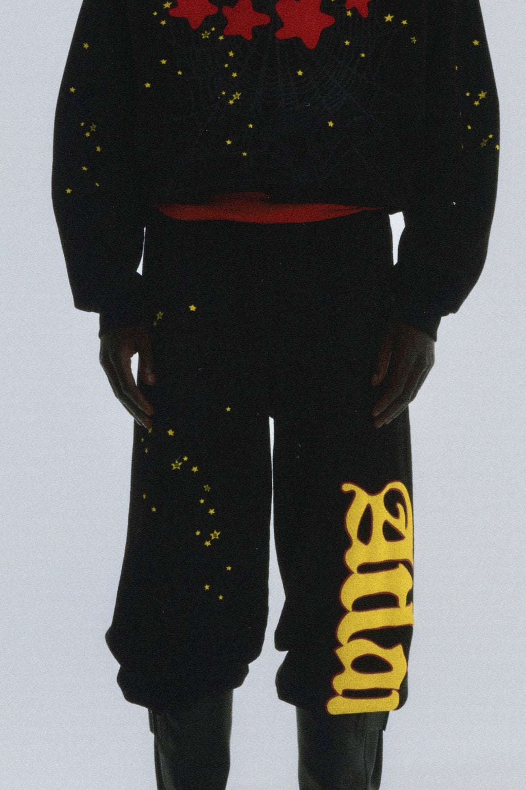 Black cotton fleece Atlanta sweatpants with yellow "Atlanta" script and scattered star print.