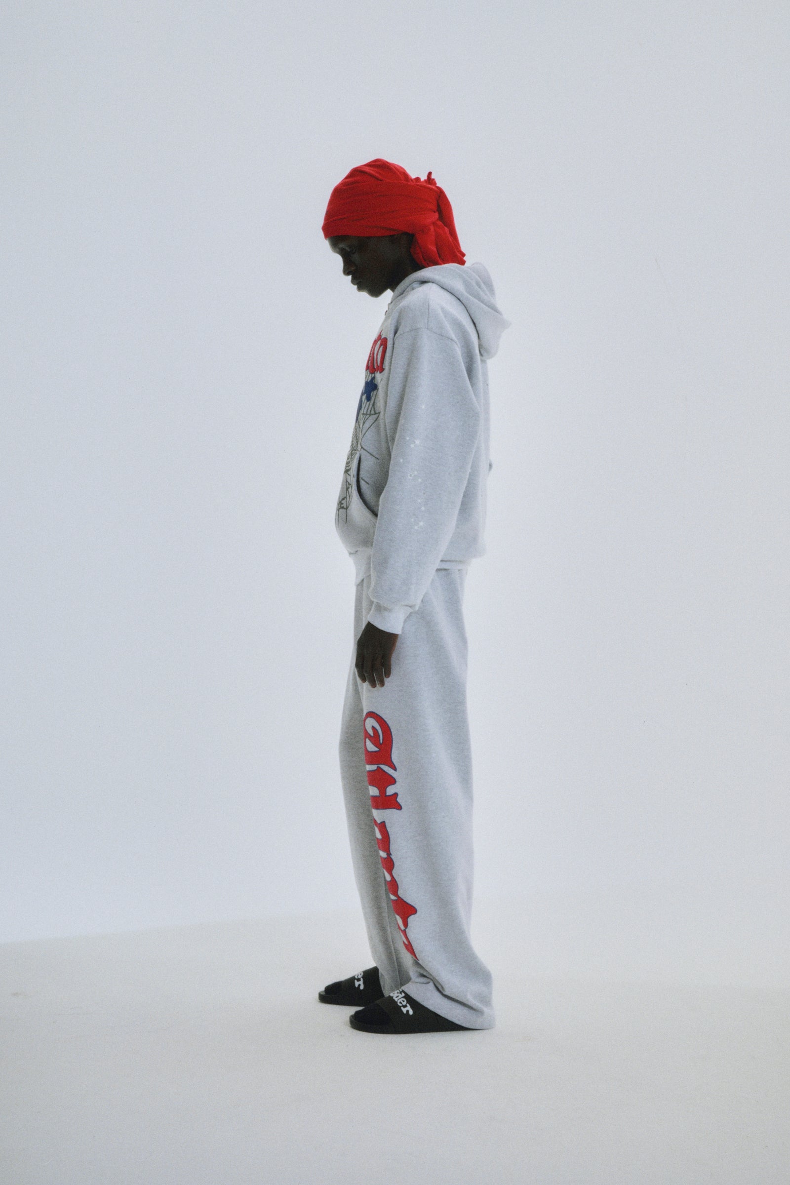 Model in grey cotton fleece Atlanta Full Zip Hoodie with scattered stars and matching sweatpants.