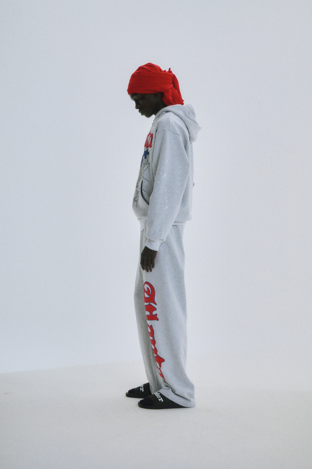 Model in grey cotton fleece Atlanta Full Zip Hoodie with scattered stars and matching sweatpants.