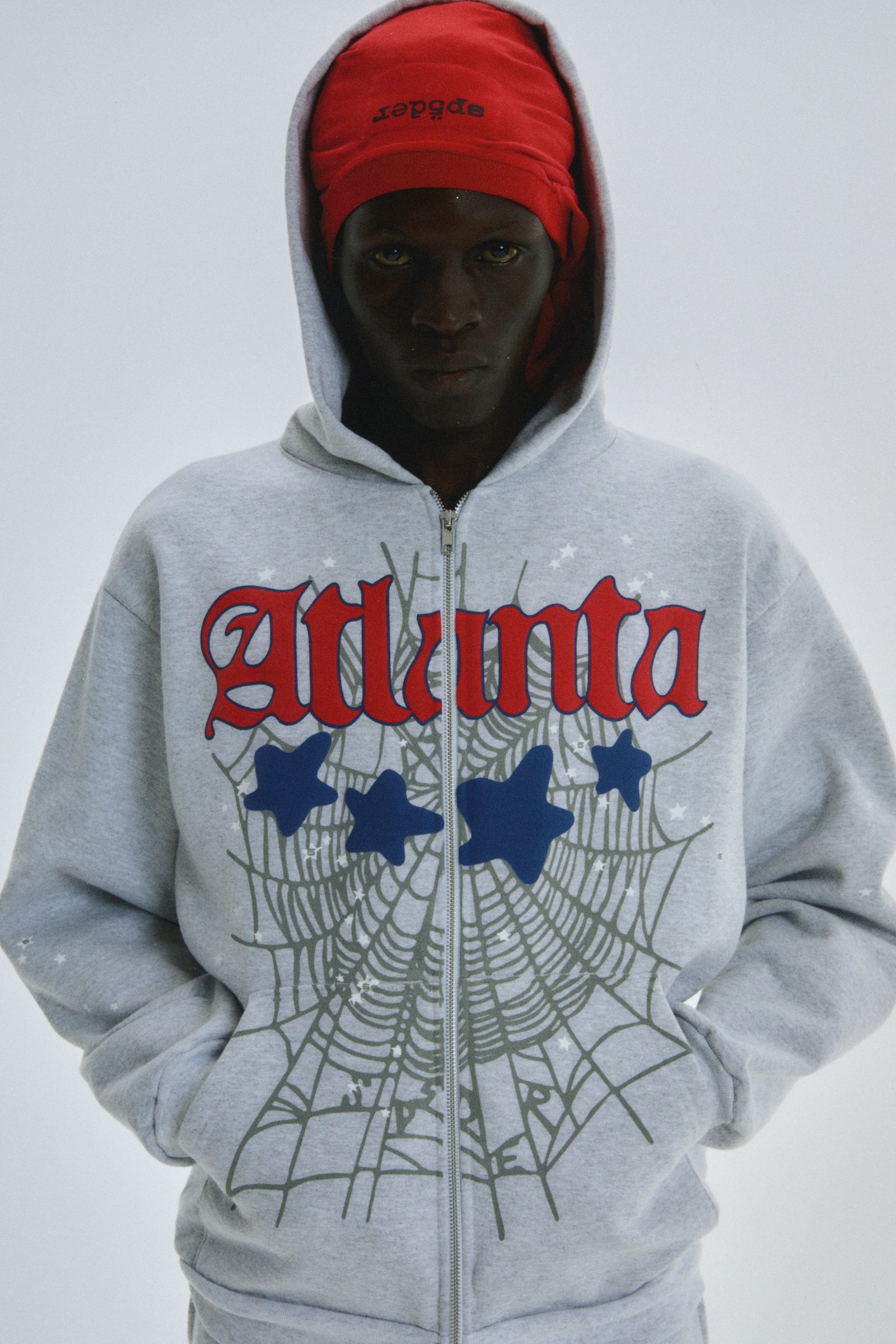 Gray 13oz cotton fleece ATLANTA FULL ZIP HOODIE with red script, spiderweb, and star prints.
