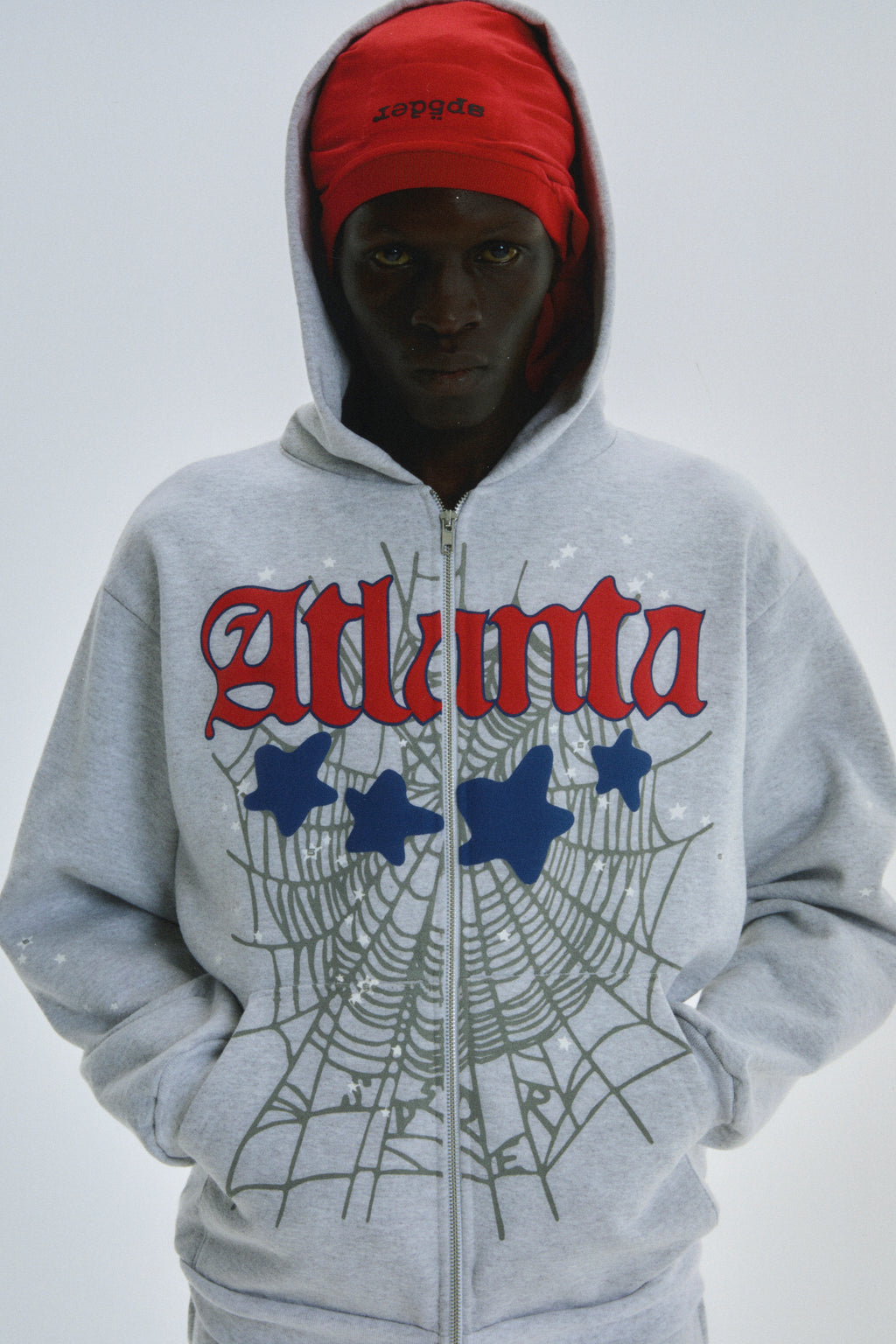 Gray 13oz cotton fleece ATLANTA FULL ZIP HOODIE with red script, spiderweb, and star prints.