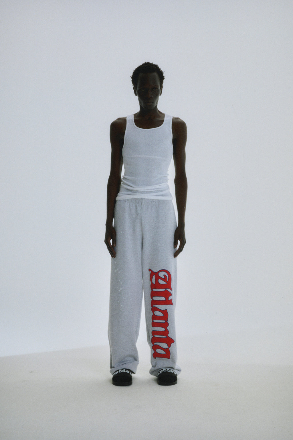 Grey wide-leg sweatpants with red "Atlanta" script and scattered stars on 100% cotton fleece.
