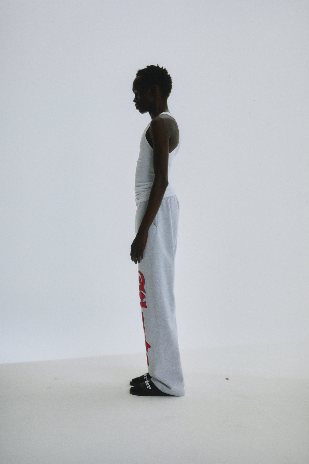 Model in light grey wide-leg cotton fleece sweatpants with red "Atlanta" script and star print.