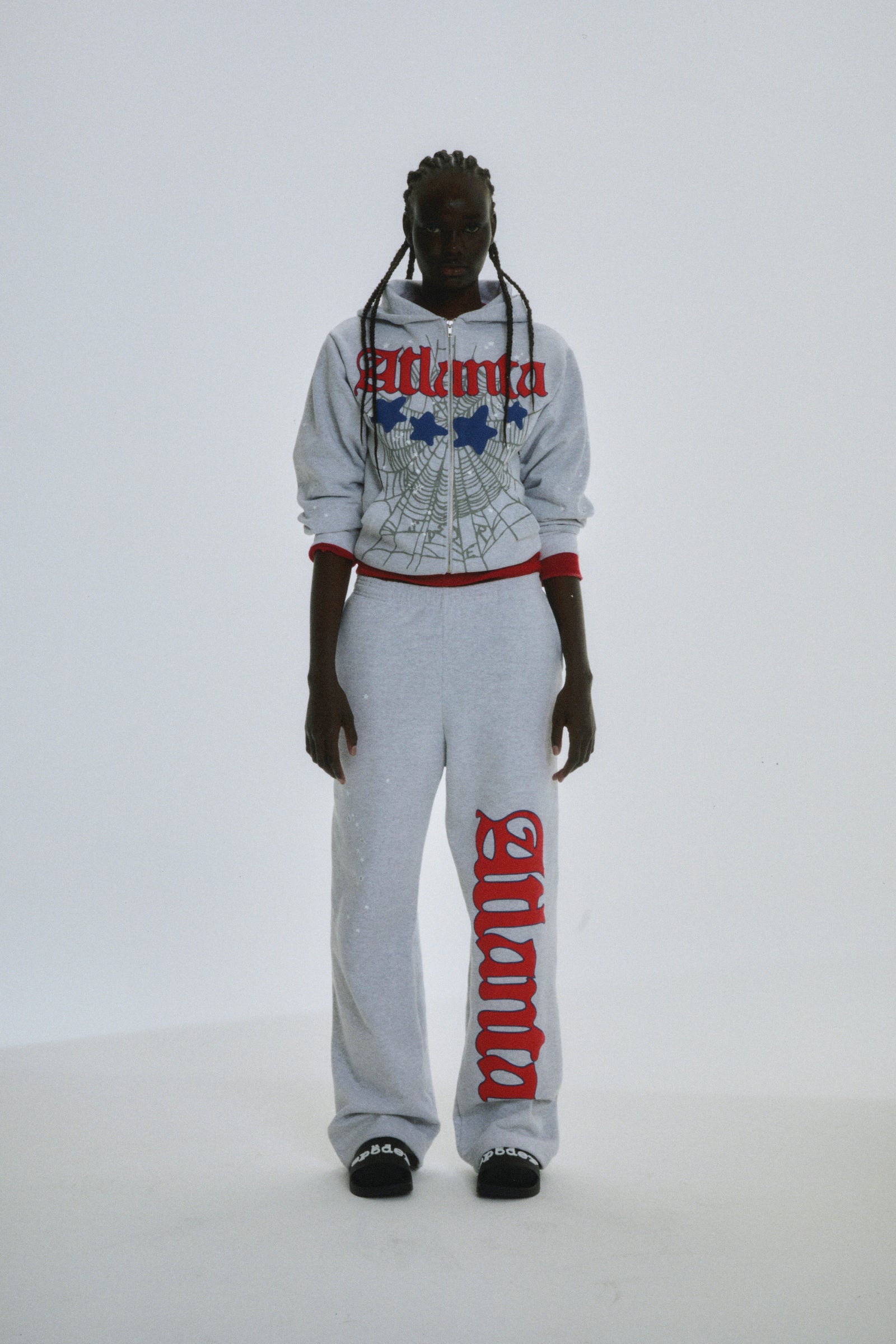 Grey 13oz cotton fleece Atlanta Full Zip Hoodie and sweatpants with red puff print, web design, and scattered stars.