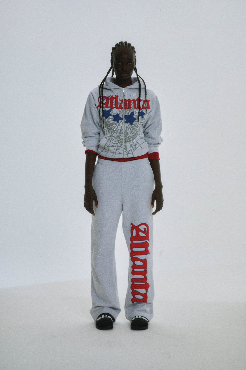 Grey 13oz cotton fleece Atlanta Full Zip Hoodie and sweatpants with red puff print, web design, and scattered stars.
