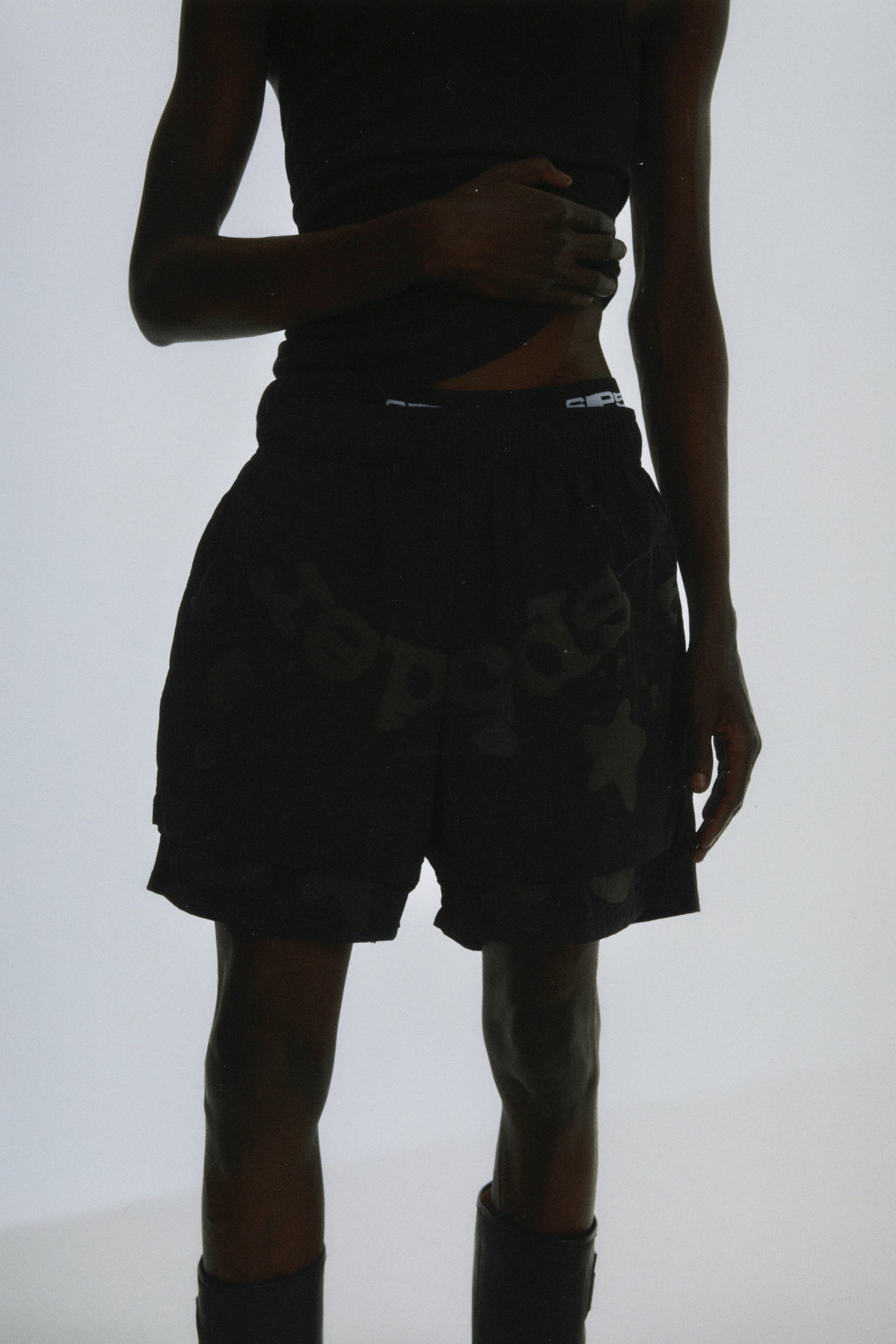 Black Beluga Double Layer Short with puff print, high-low design, and elastic waistband.
