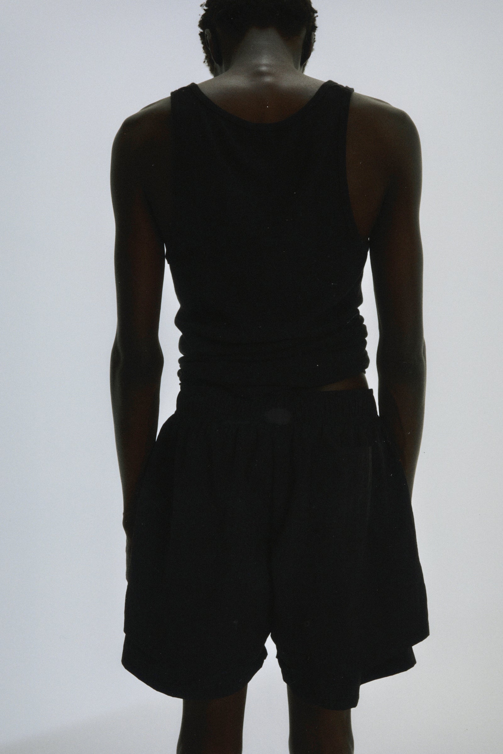 Black Beluga Double Layer Short, 4oz water repellent nylon, high-low design, with patch back pocket.
