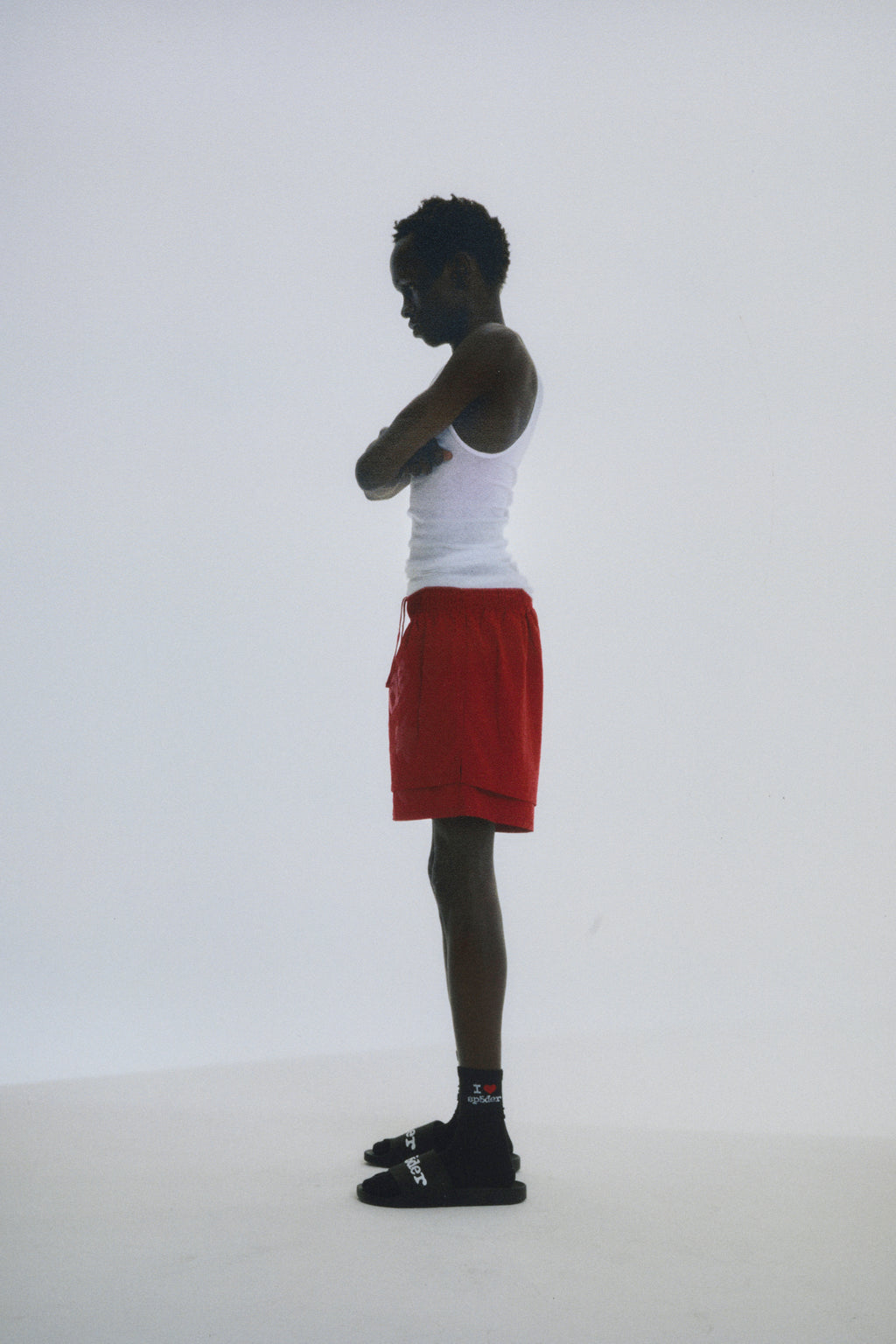 Model in red Beluga Double Layer Shorts, 4oz water-repellent nylon, with high-low design and puff print.