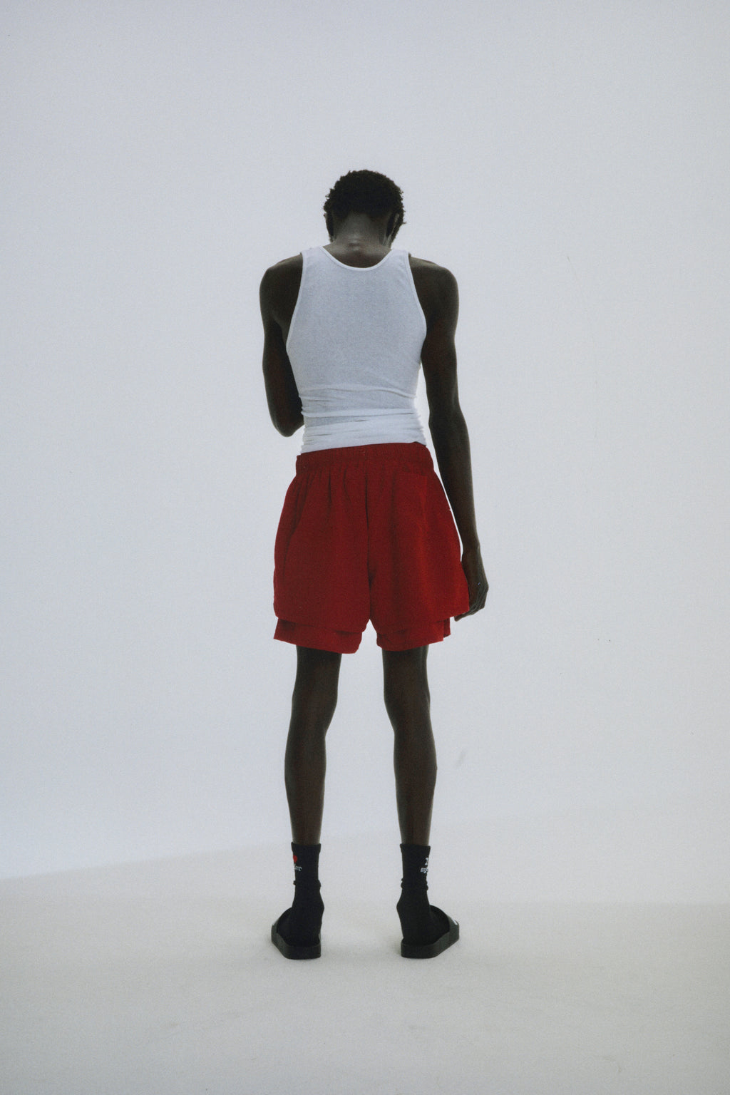 Red Beluga Double Layer Short, 4oz water repellent nylon, high-low design, worn by a person from behind.