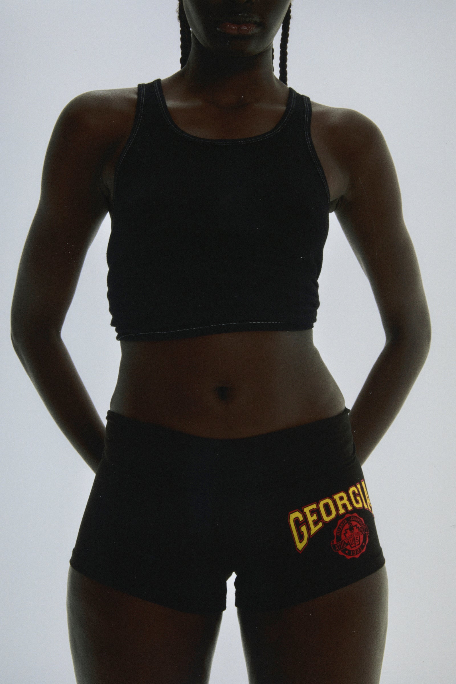 Black stretch cotton jersey short with "GEORGIA" collegiate graphic on front, worn by a person.