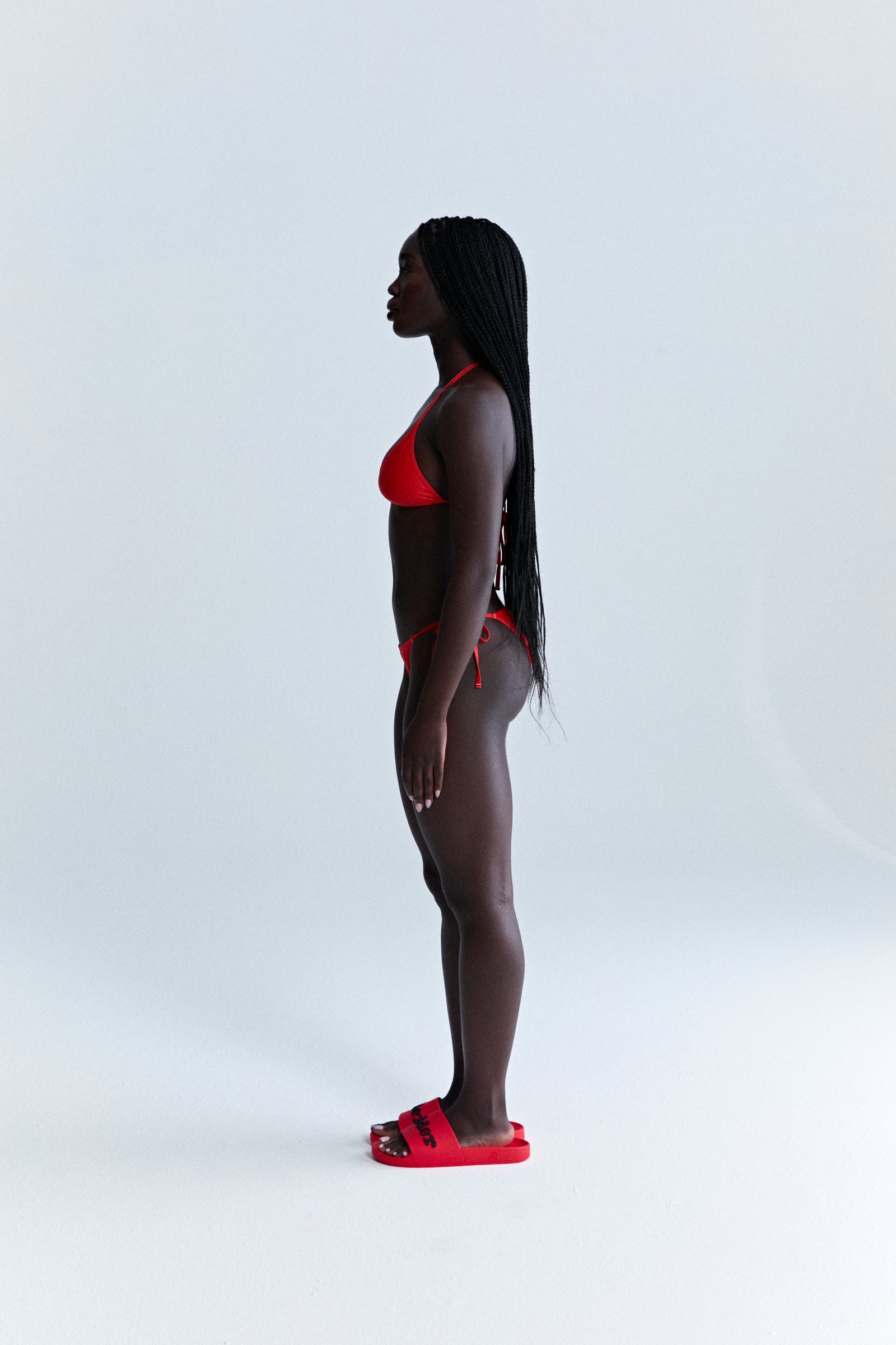 Red ARAIGNÉE BIKINI set with triangle top and rope ties, made of stretch nylon jersey.