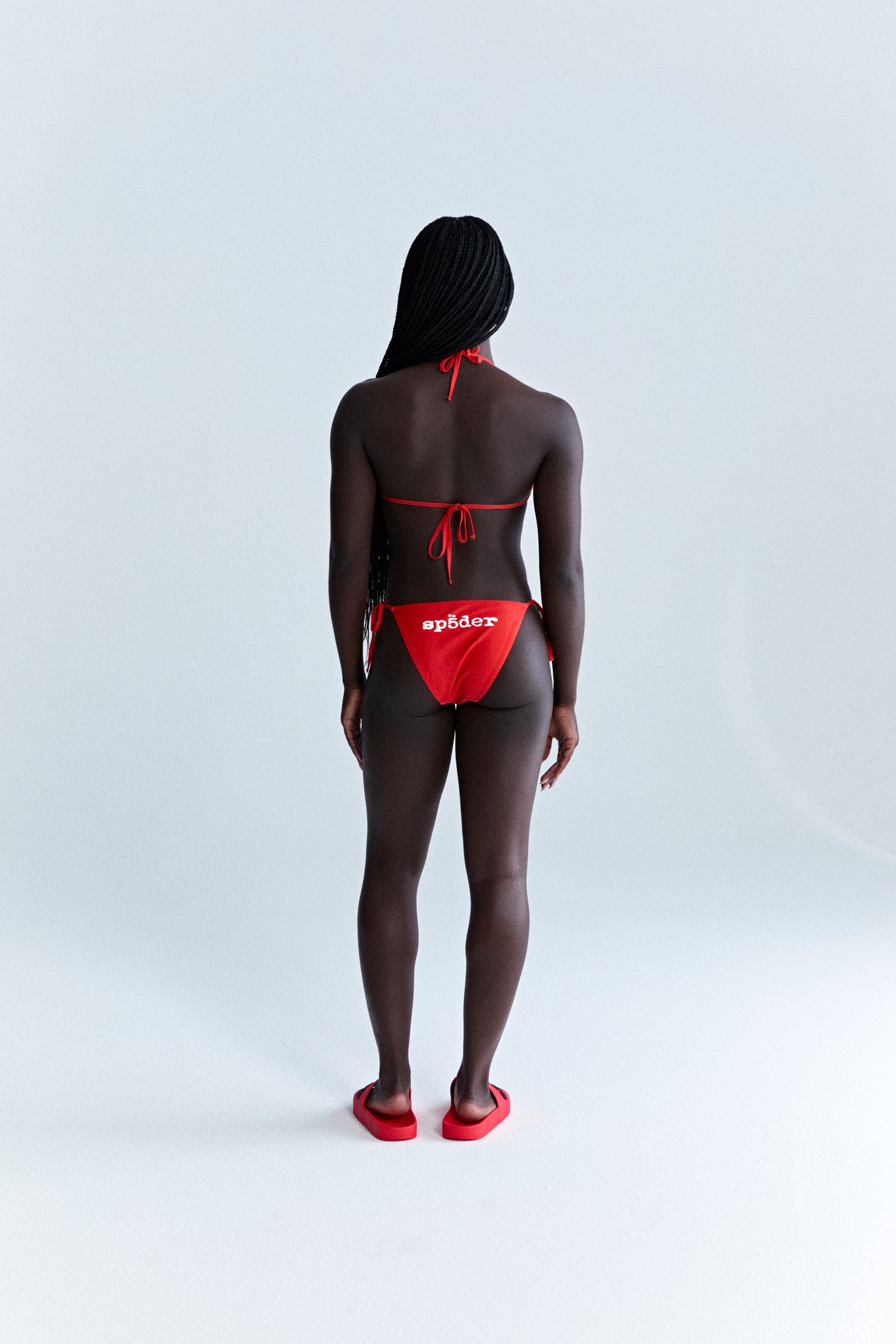Red stretch nylon jersey bikini set with "sp5der" logo on bottom, rope ties.
