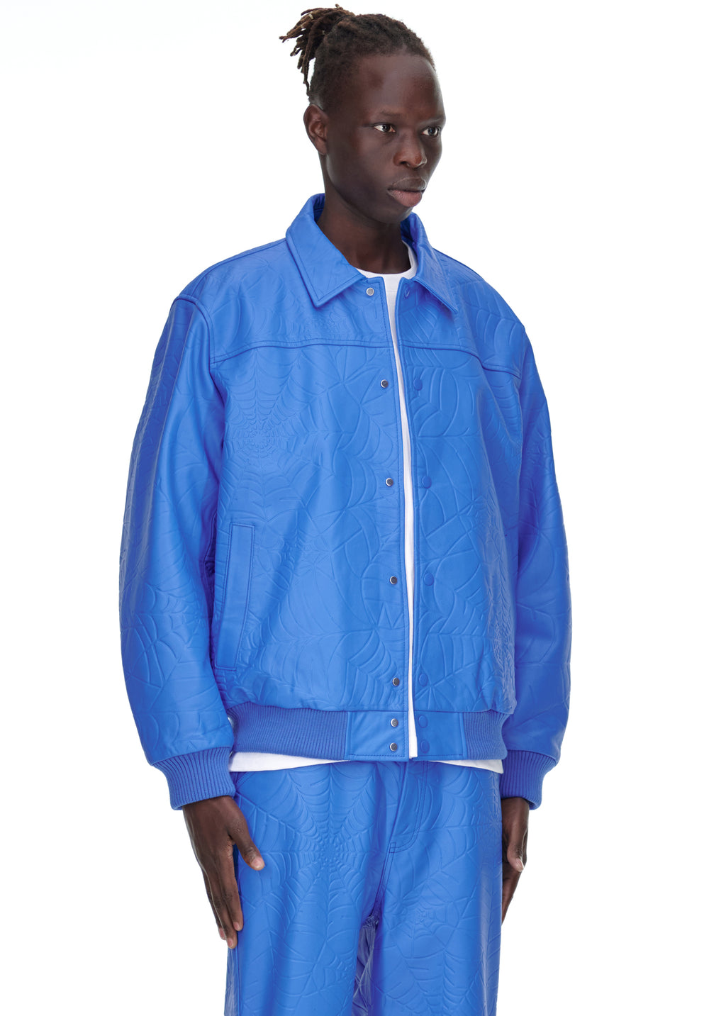 Male model in a blue debossed web cowskin leather jacket with a spread collar and ribbed cuffs.