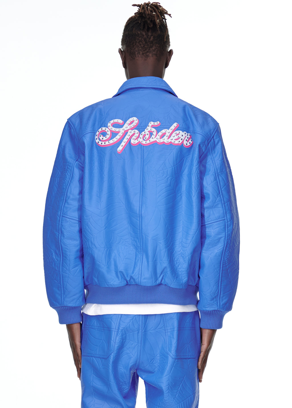 Blue debossed web cowskin leather jacket with "Spider" studded text on back, worn by a male model.