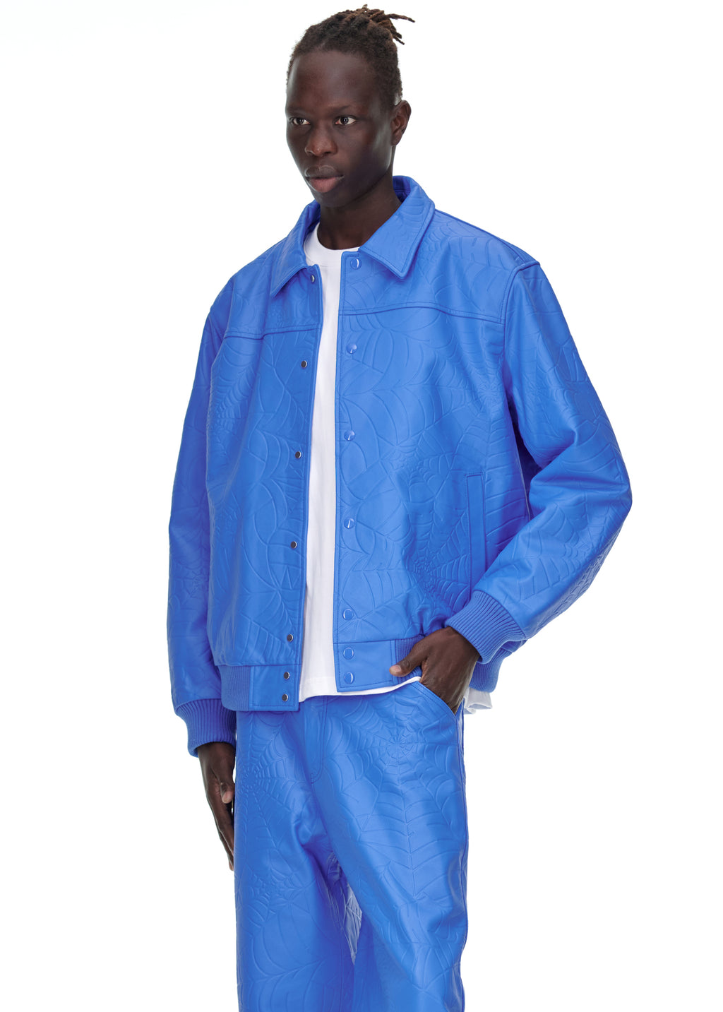 Male model in a blue debossed web cowskin leather jacket with a spread collar and ribbed cuffs.