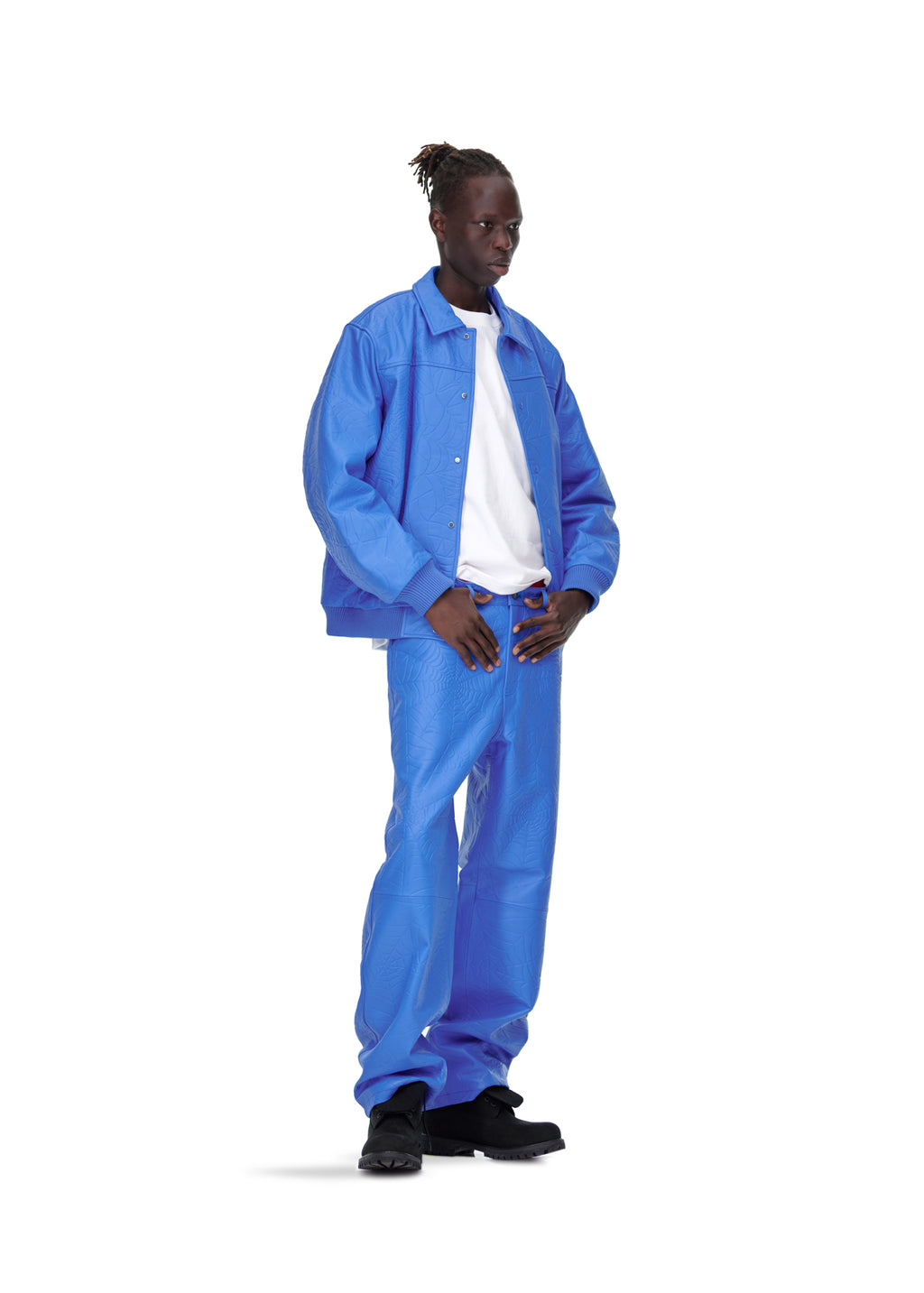 Male model in blue debossed web cowskin leather jacket and matching pants.