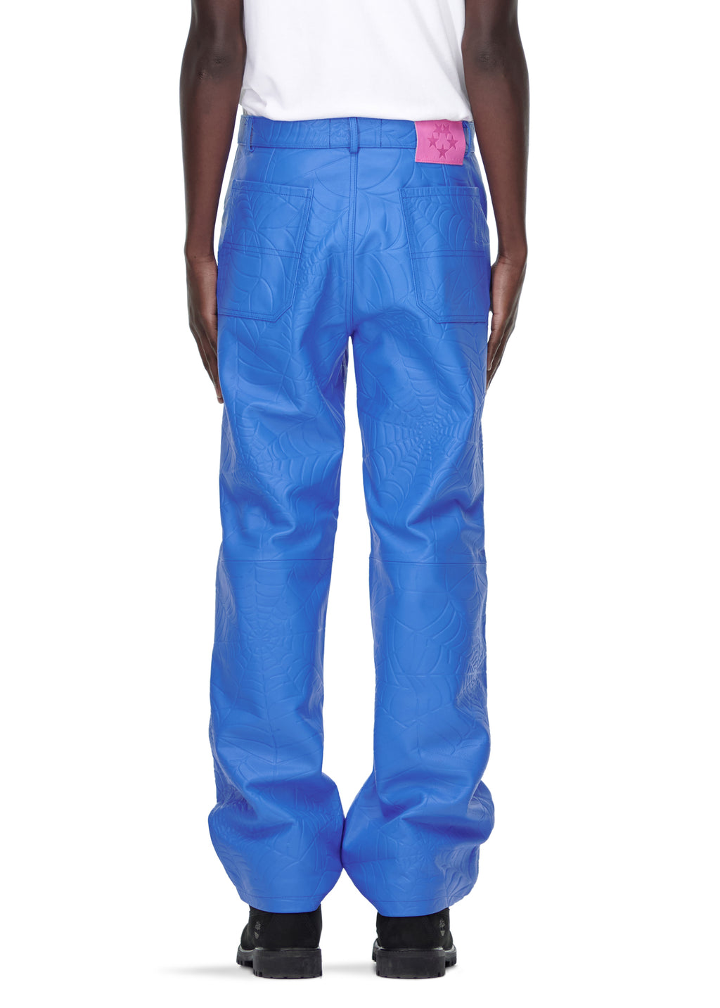 Blue debossed web leather pants with a pink suede logo patch, worn by a male model.