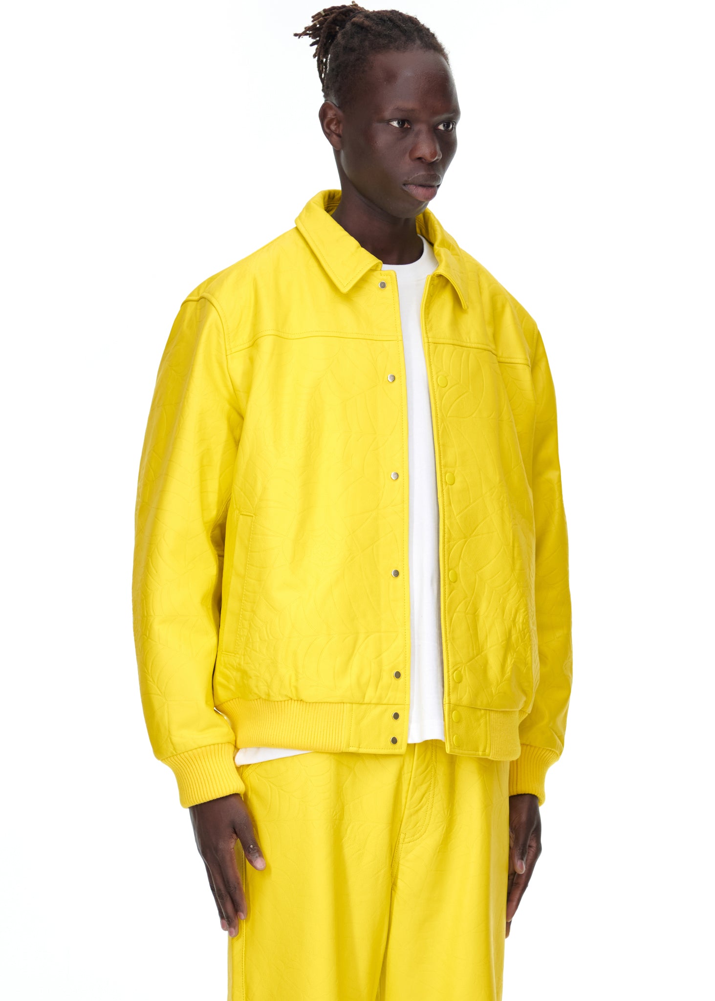 Male model in a bright yellow debossed web cowskin leather jacket with a spread collar.