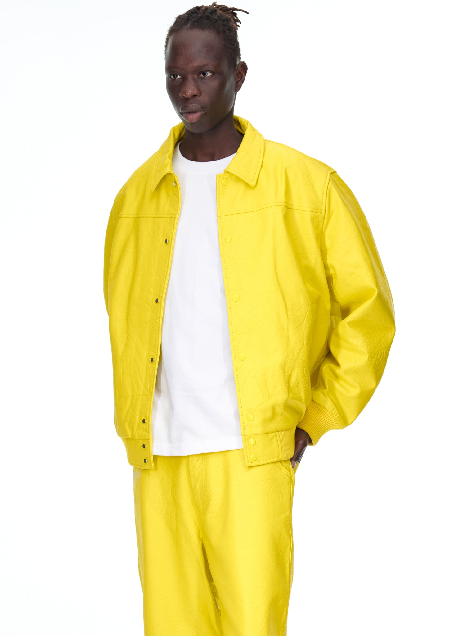 Male model in a bright yellow debossed web cowskin leather jacket with a white t-shirt.