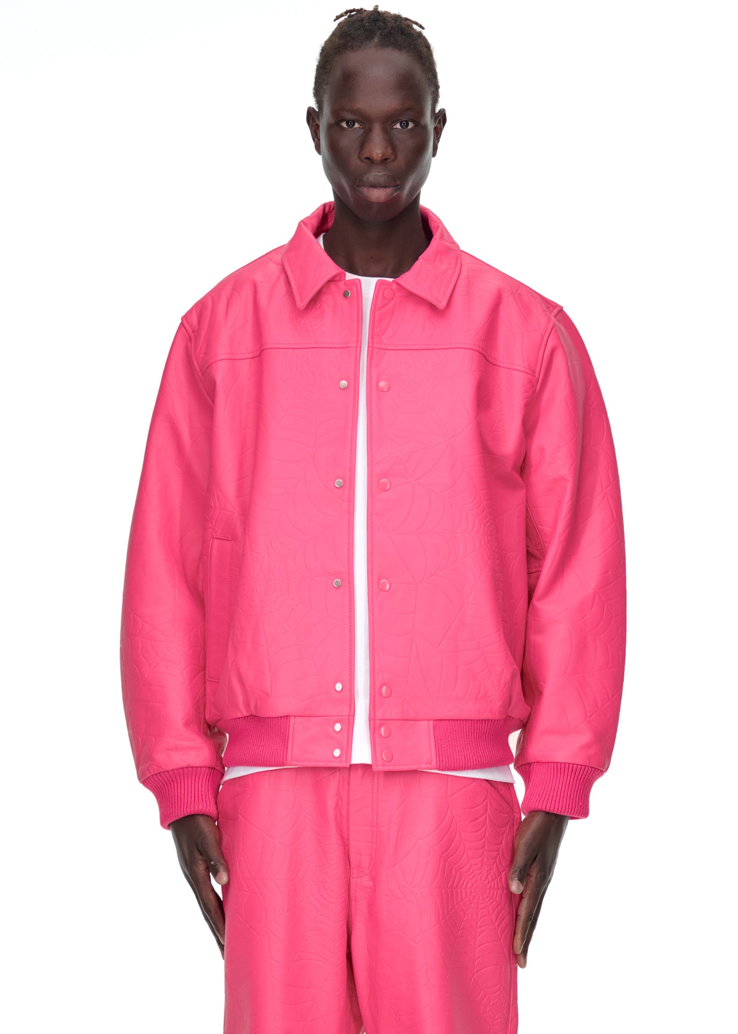 Male model in a pink debossed web cowskin leather jacket with a spread collar and press-stud closure.