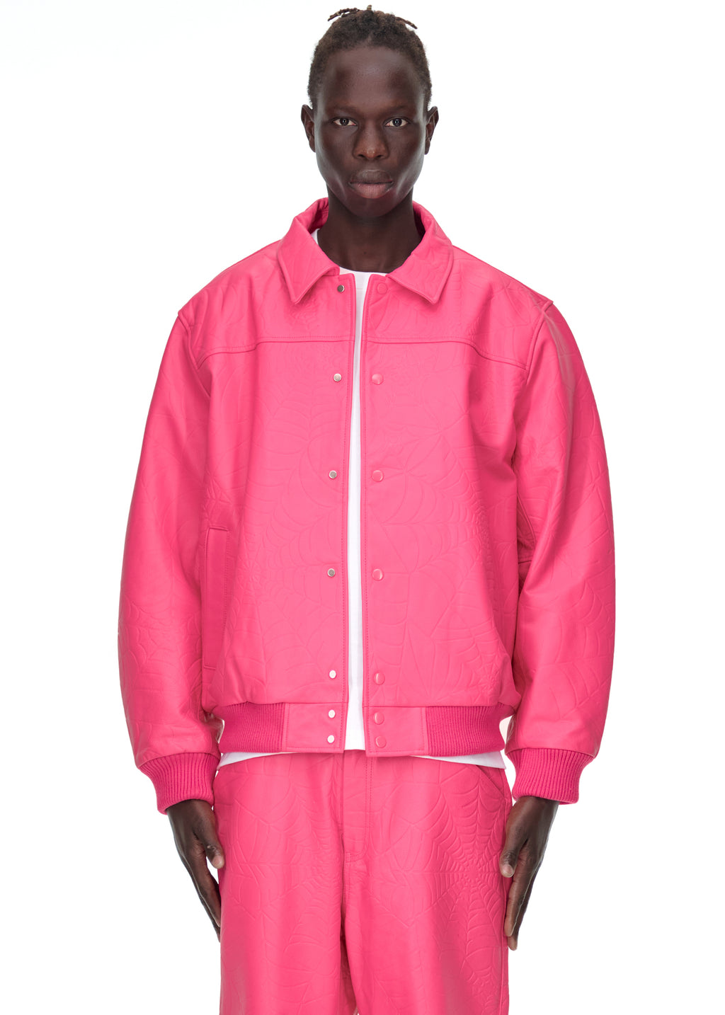 Male model in a pink debossed web cowskin leather jacket with a spread collar and press-stud closure.