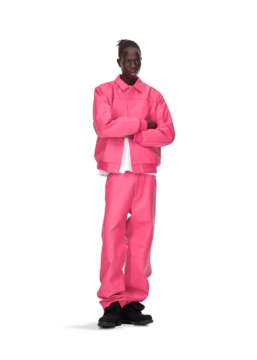 Male model in a pink debossed web cowskin leather jacket and matching pants.