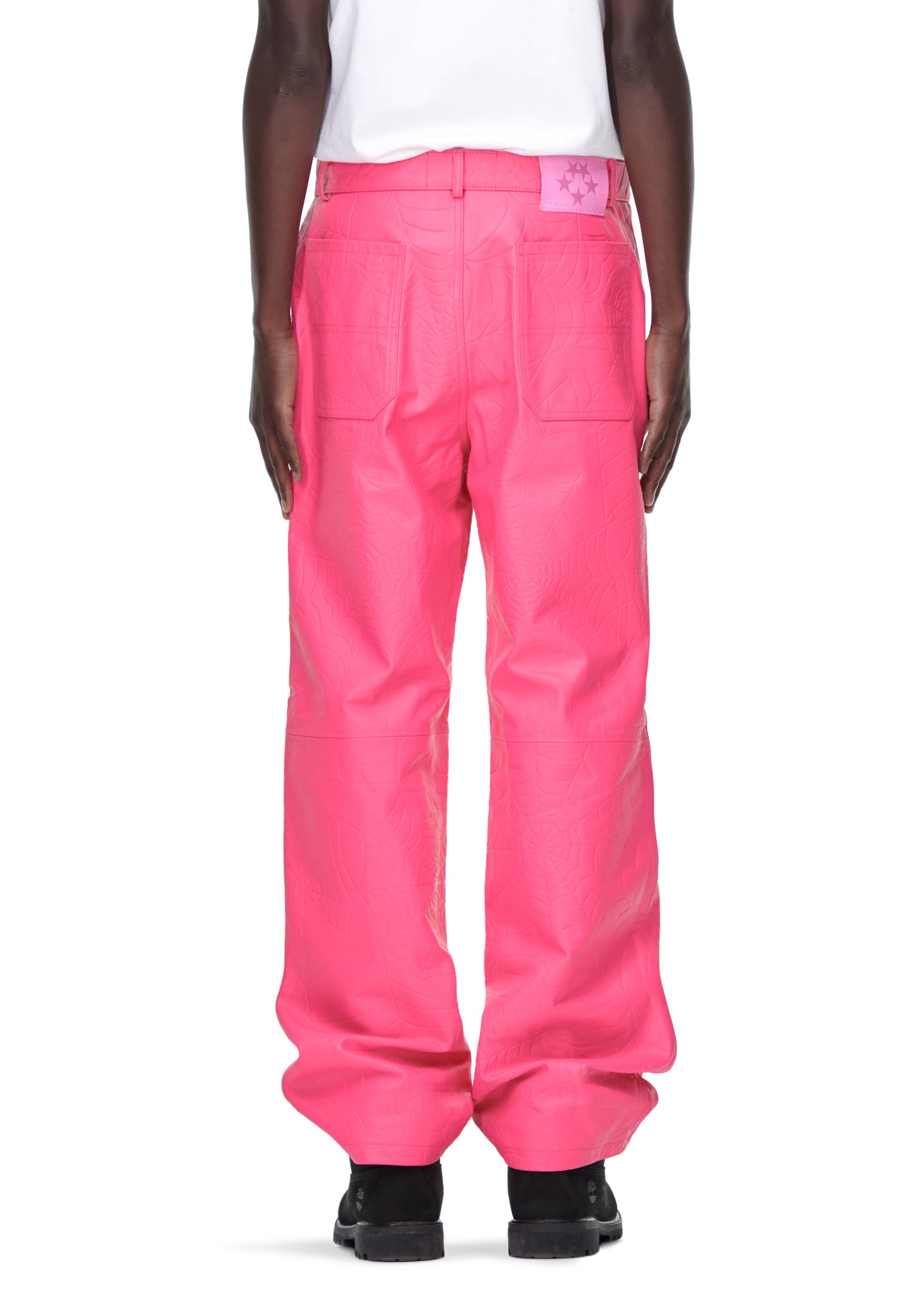 Men's pink cowskin leather pants with debossed web design and pink suede logo patch.