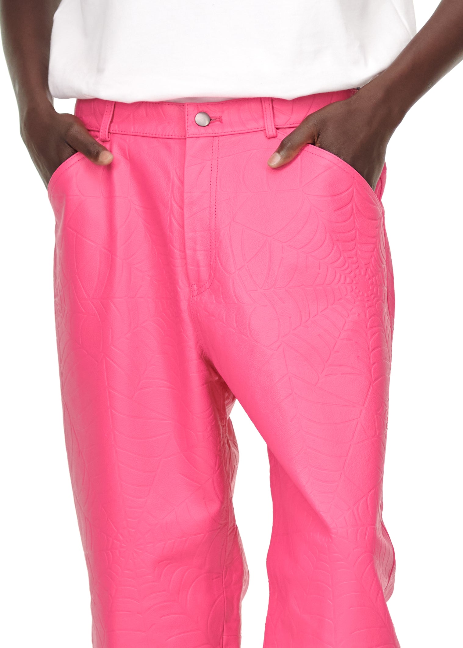 Close-up of pink debossed web cowskin leather pants with button fly and belt loops.