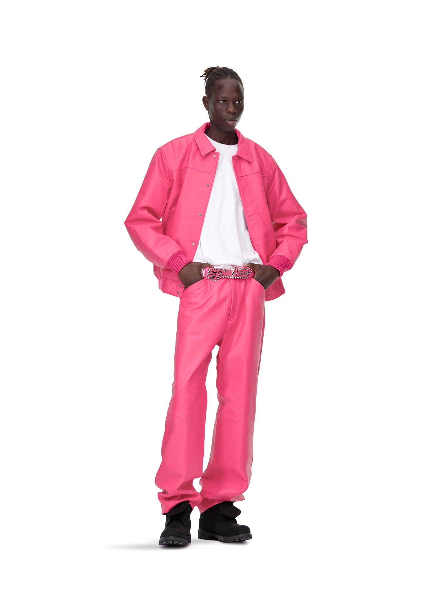 Male model in pink debossed web cowskin leather pants and matching jacket with a white tee.