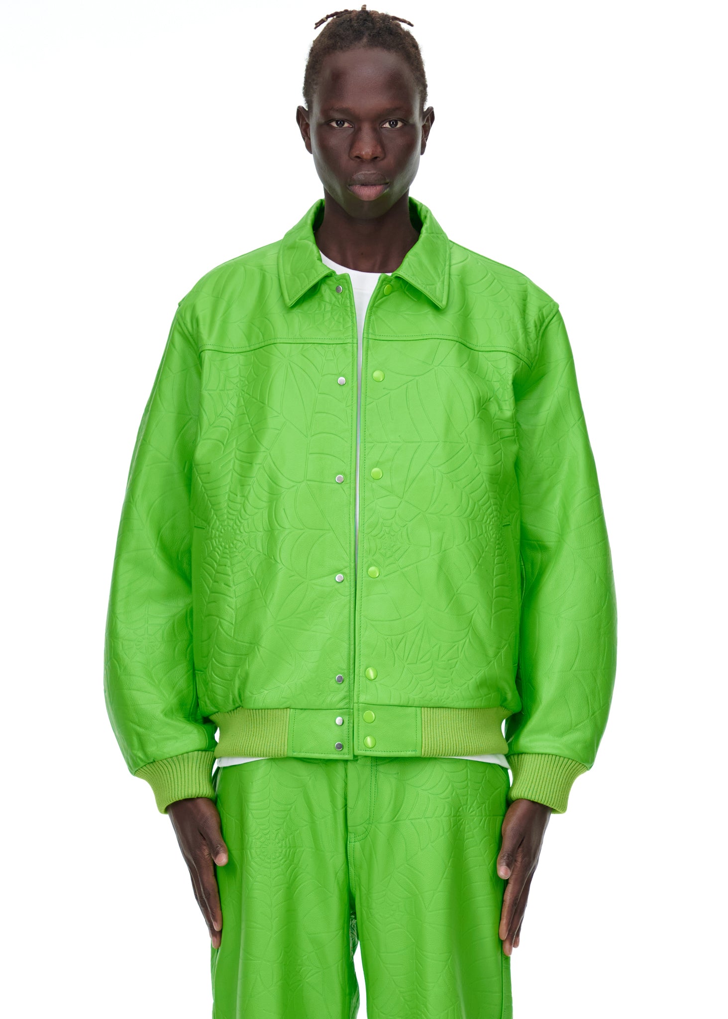 Male model in a bright green debossed web leather jacket with a spread collar and press-stud closure.