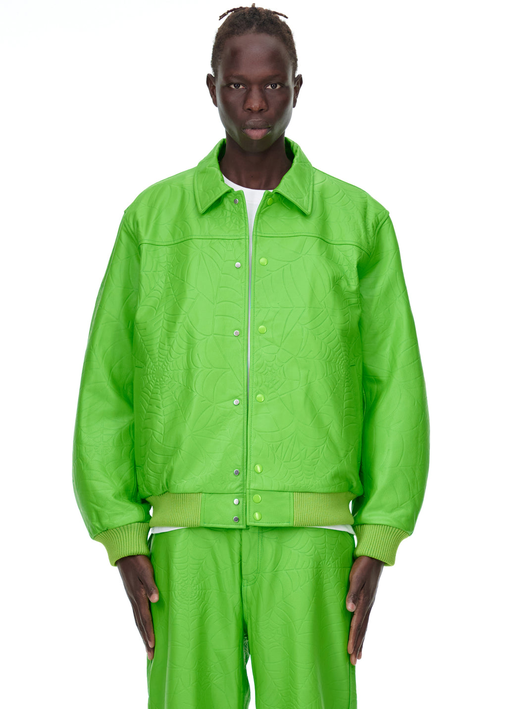 Male model in a bright green debossed web leather jacket with a spread collar and press-stud closure.