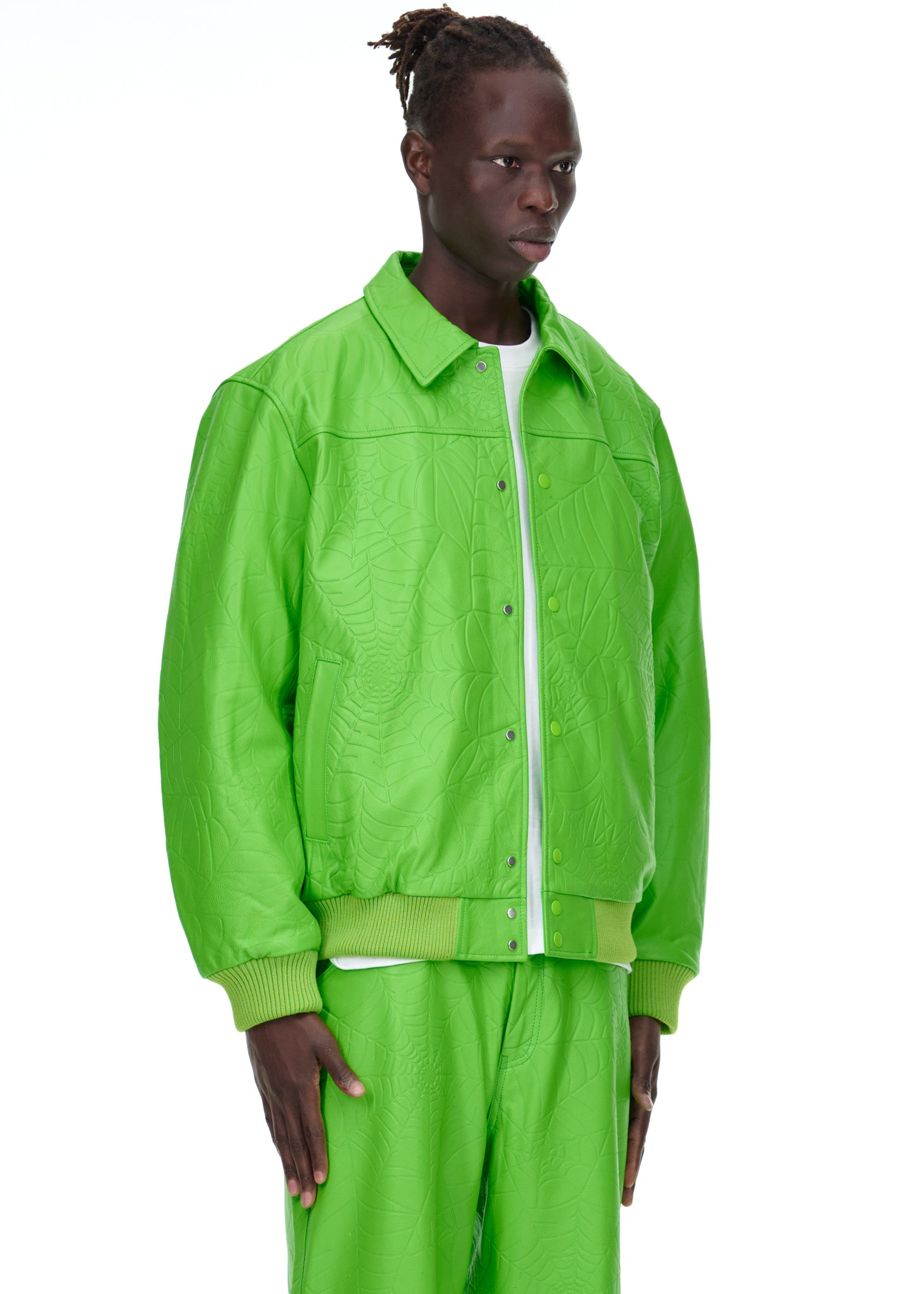 Male model in a lime green debossed web cowskin leather jacket with a spread collar and press-stud closure.