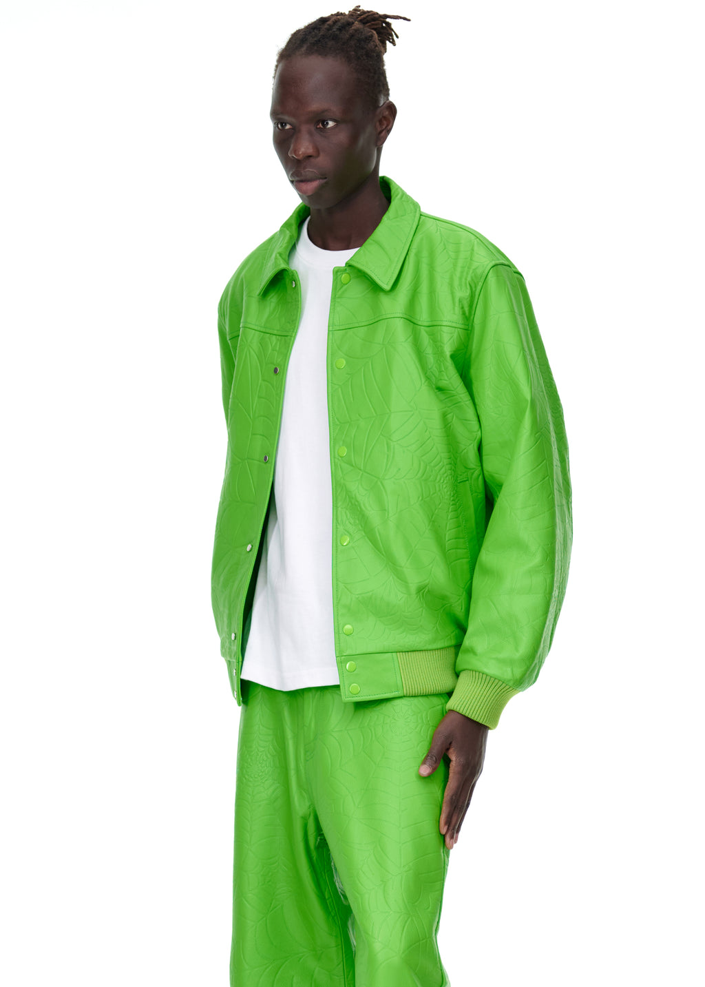 Male model in a lime green debossed web leather jacket and matching pants.
