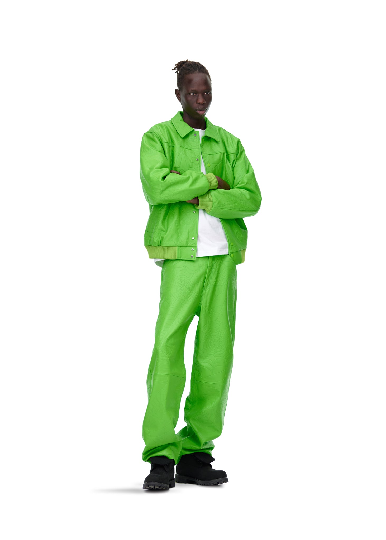 Male model in a bright green debossed web cowskin leather jacket and matching pants.
