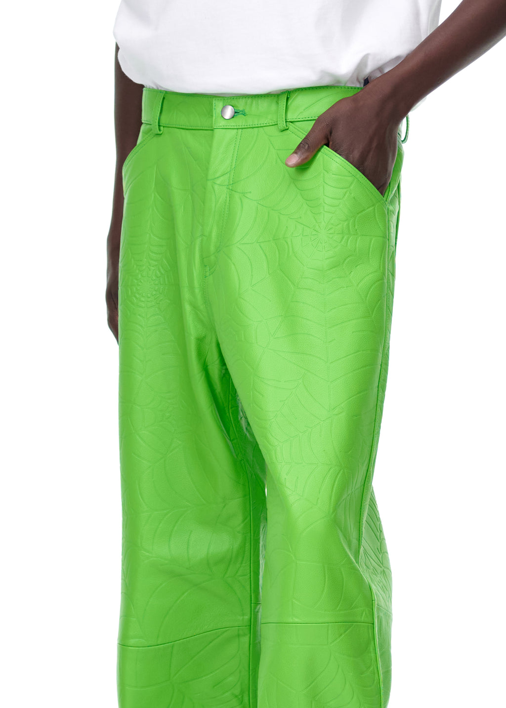 Bright green debossed web leather pants with a pink suede logo patch, worn by a male model.