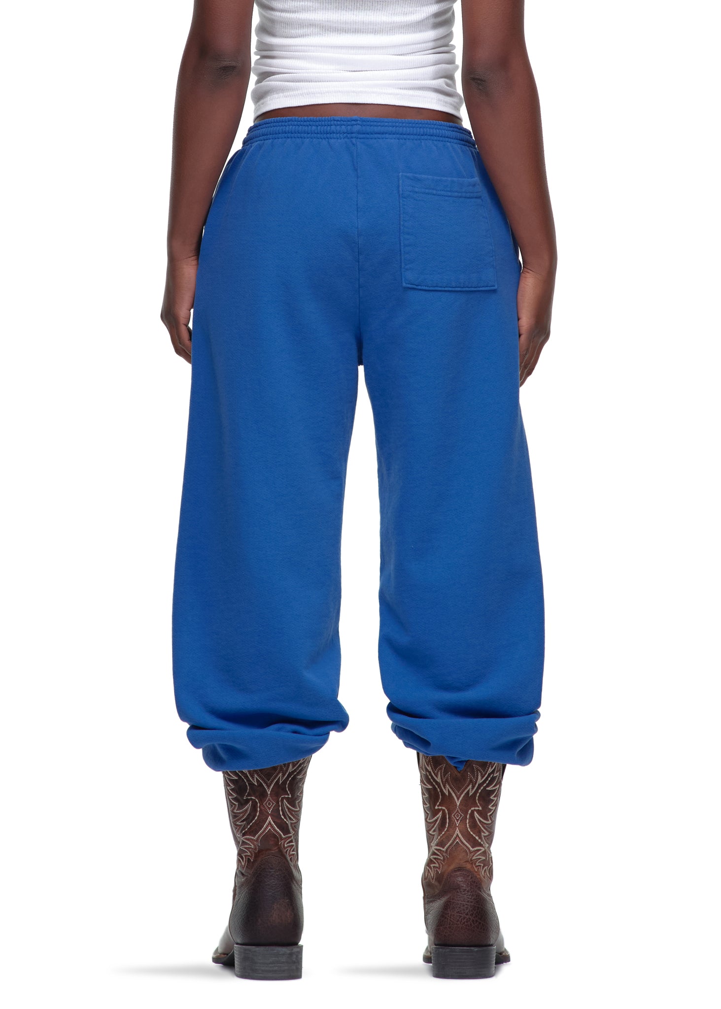 Blue 23oz fleece Legacy Sweatpants with puff/discharge print, worn by a model from behind.