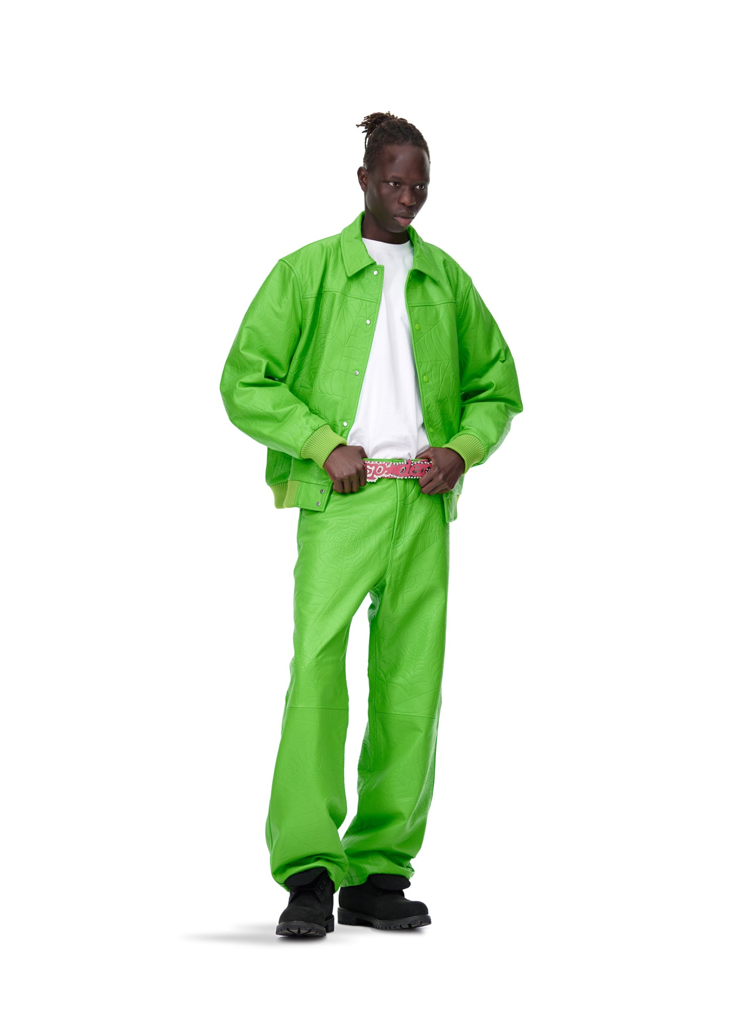 Male model in lime green debossed web leather pants and matching jacket with a white t-shirt.
