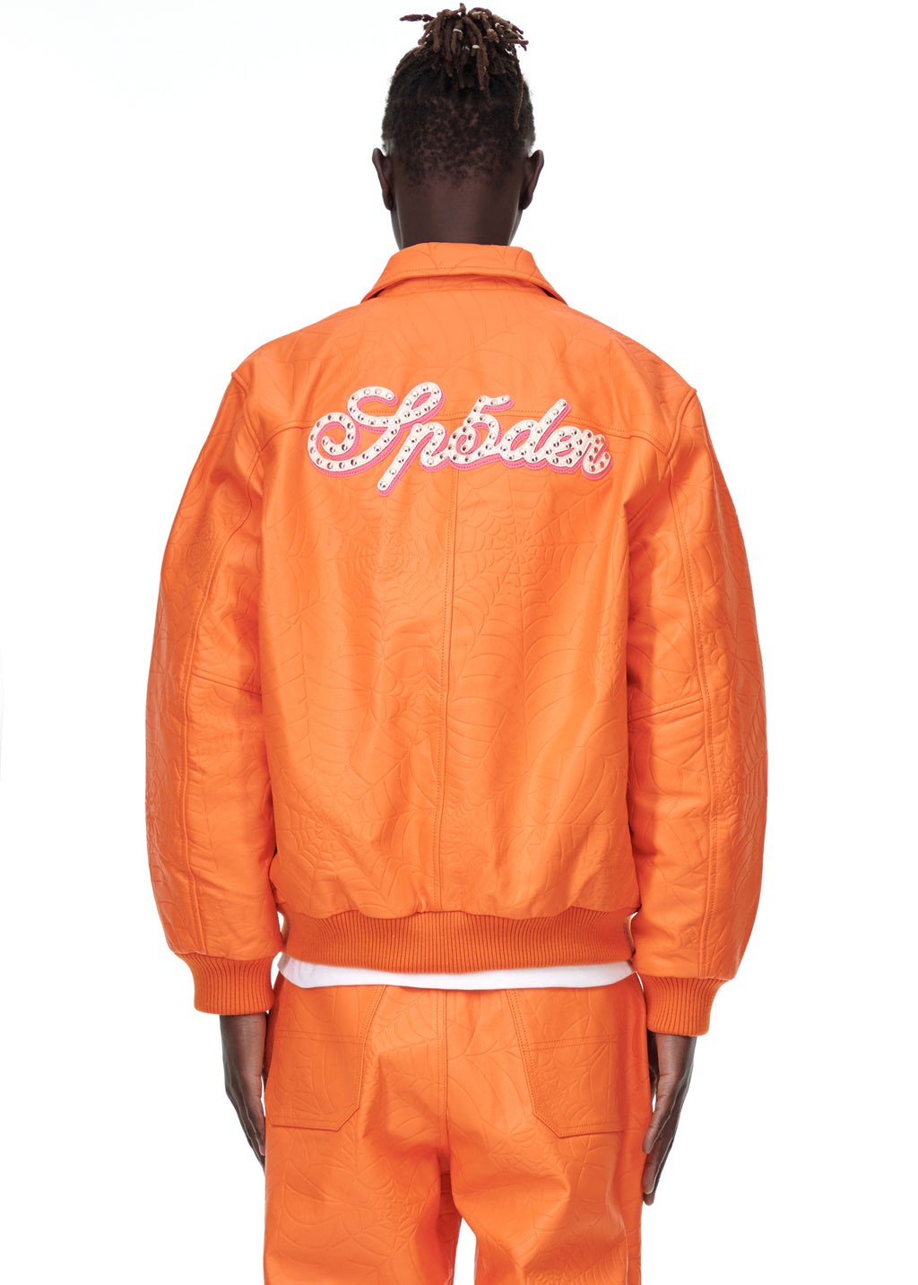 Orange debossed web cowskin leather jacket with "Sp5der" studded text on the back.