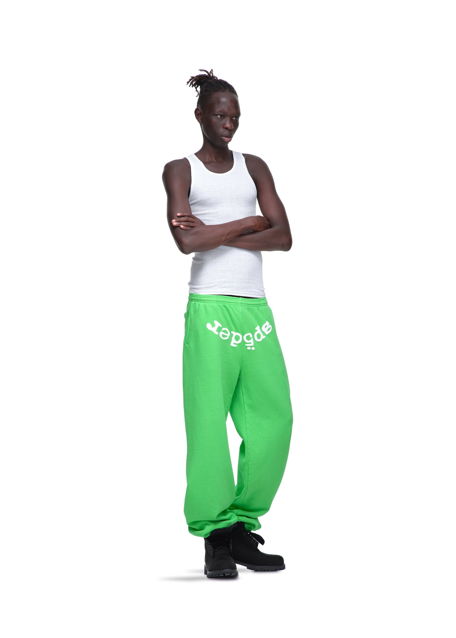 Model in bright green LEGACY SWEATPANTS with white "sp5der" puff print, made from 23oz fleece.