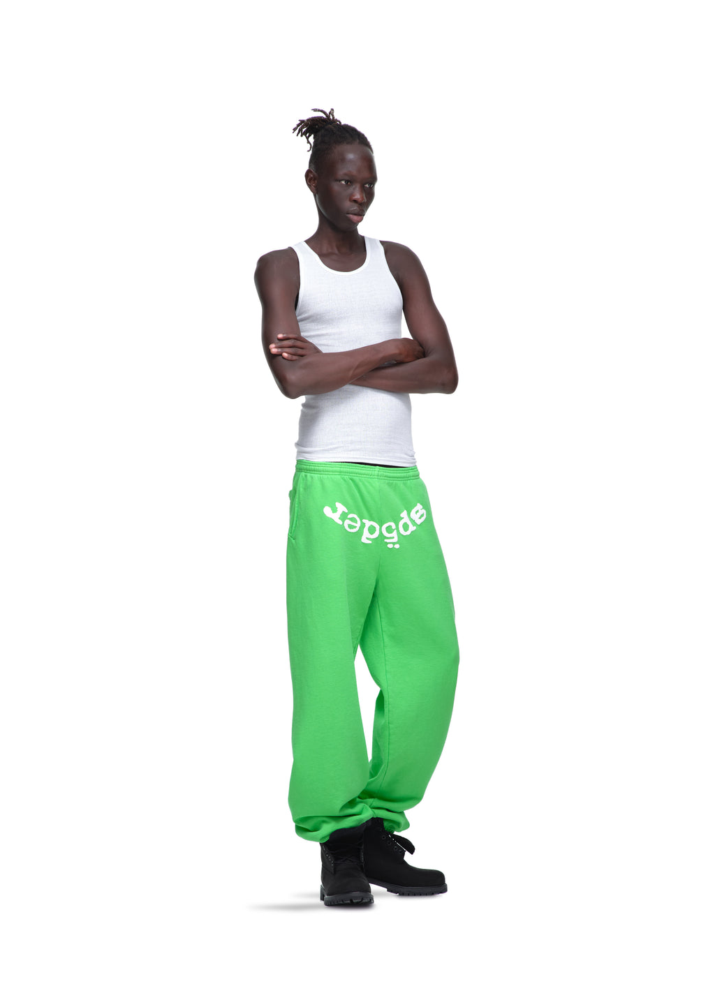 Model in bright green LEGACY SWEATPANTS with white "sp5der" puff print, made from 23oz fleece.