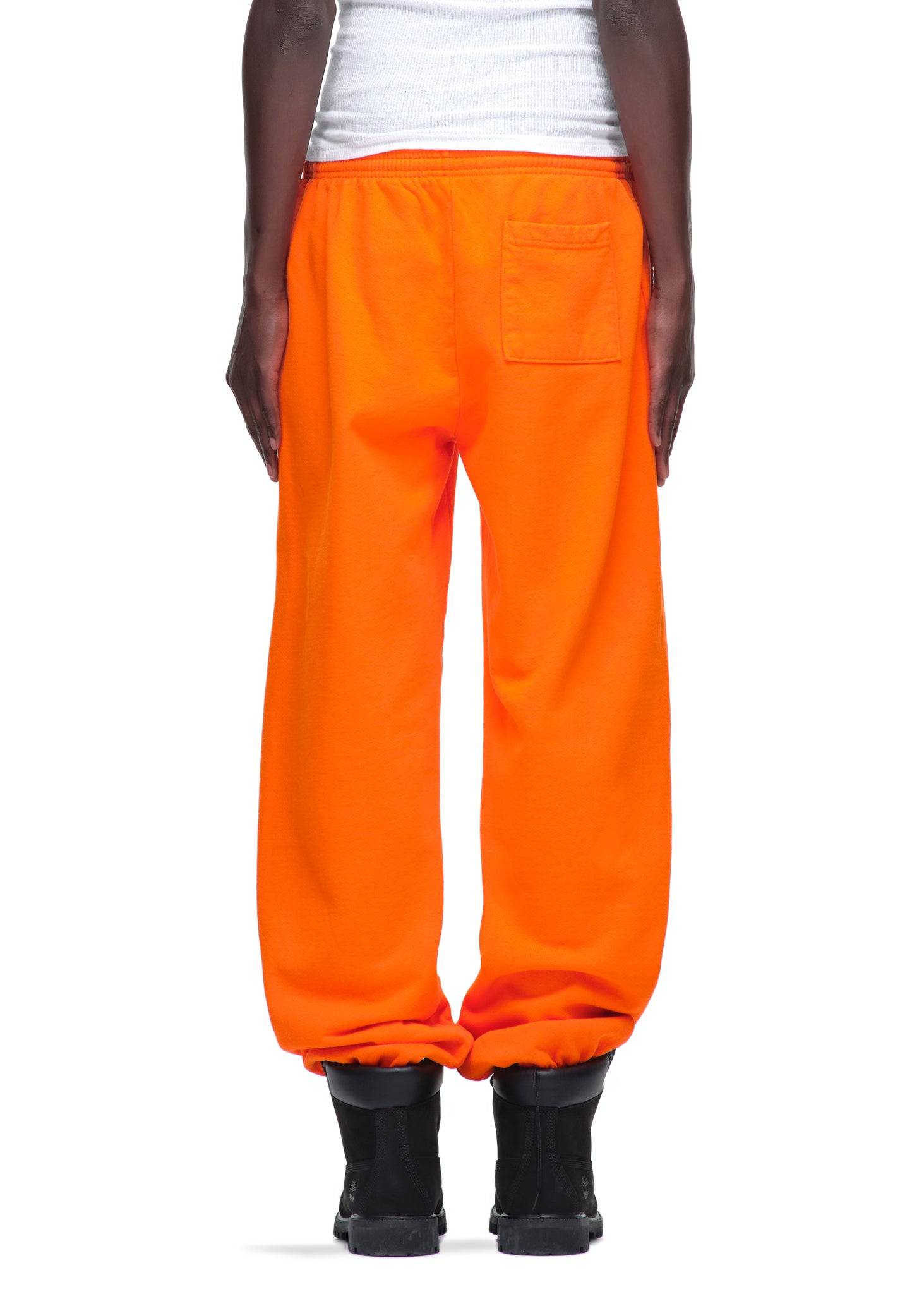 Orange LEGACY SWEATPANT, 23oz fleece, with a back pocket, worn by a person.