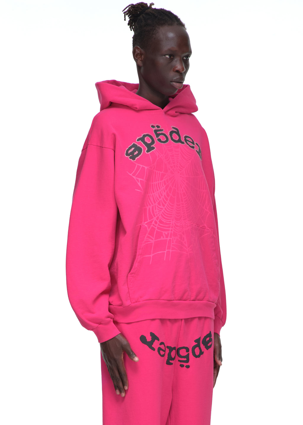 Male model in a hot pink Legacy Hoodie with rhinestone "Sp5der" text and a large spider web print.