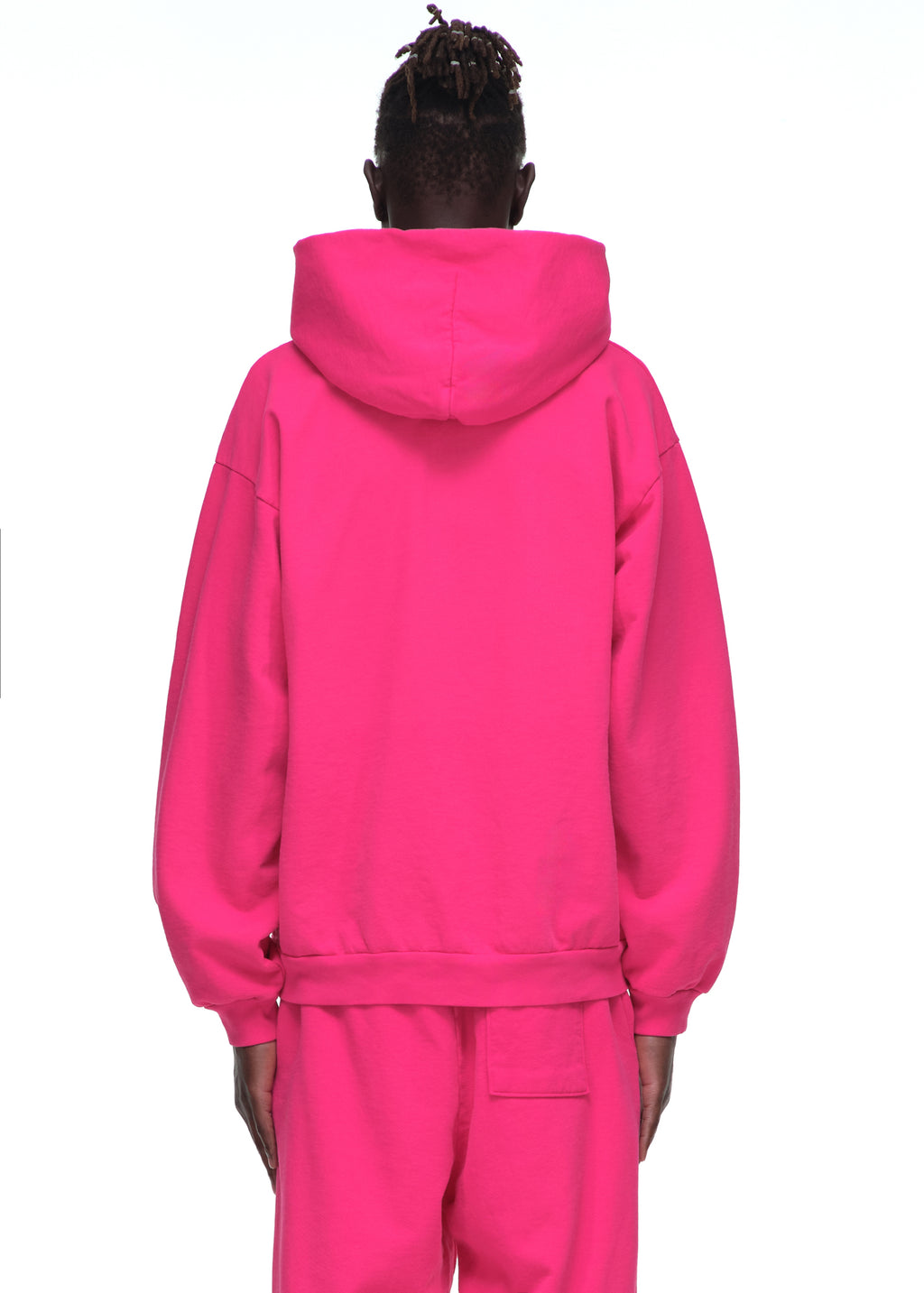 Back view of a person wearing a bright pink fleece Legacy Hoodie and matching sweatpants.