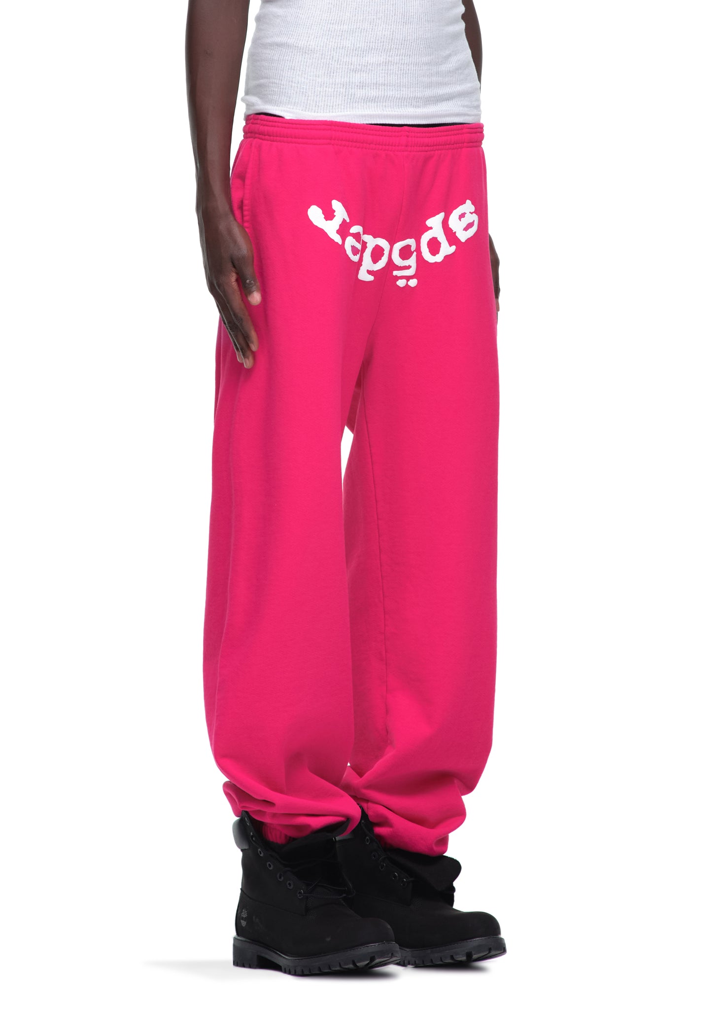 Pink LEGACY SWEATPANT with white "Sp5der" puff print, 23oz fleece, worn by a model.