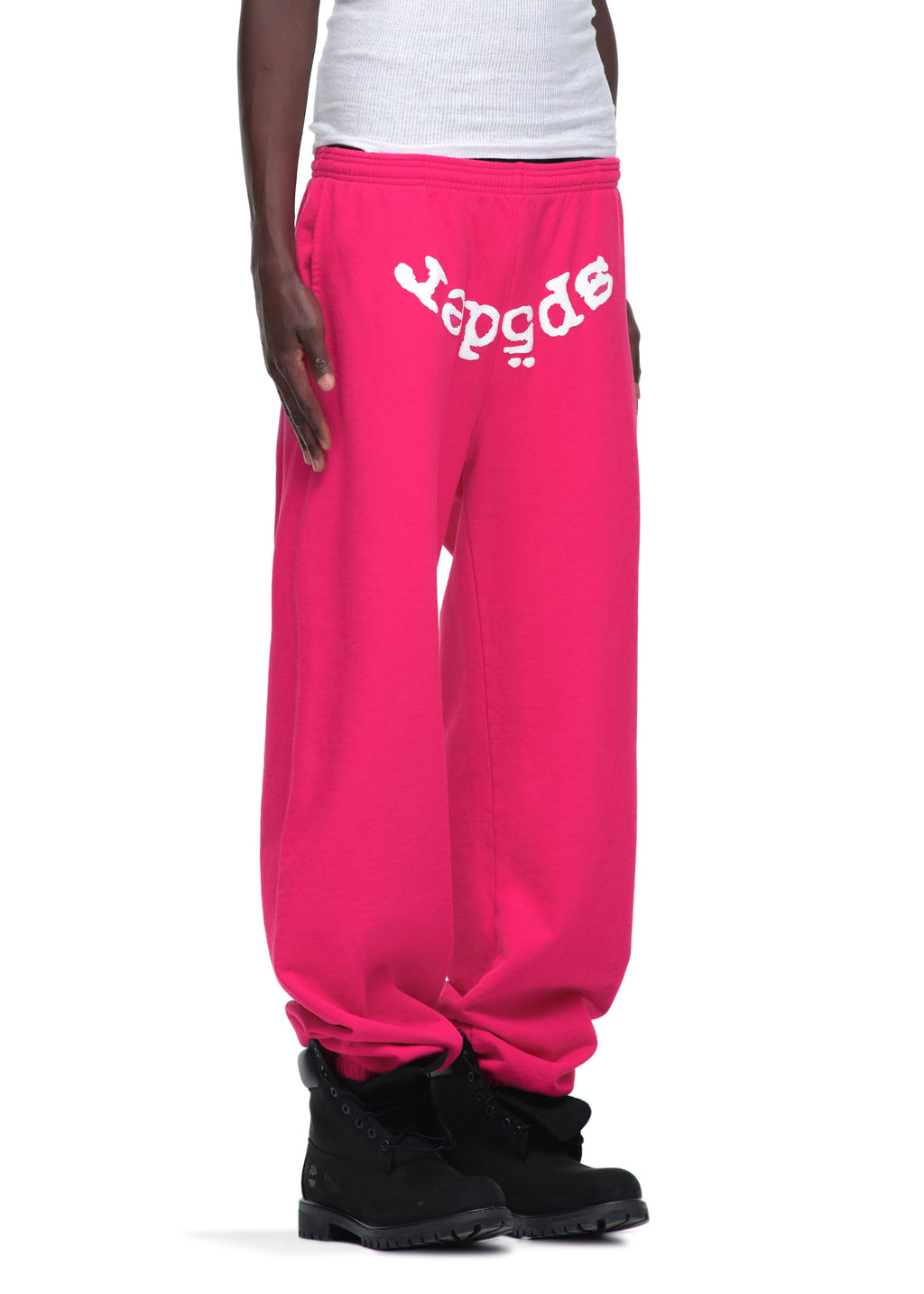 Pink LEGACY SWEATPANT with white "Sp5der" puff print, 23oz fleece, worn by a model.