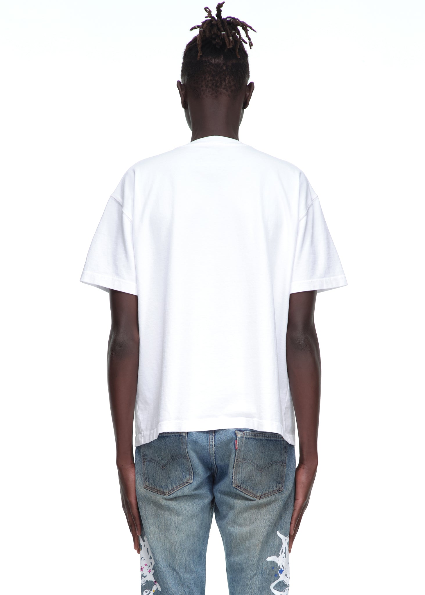 Back view of a male model wearing a plain white 14oz cotton Souvenir Tee with standard fit.