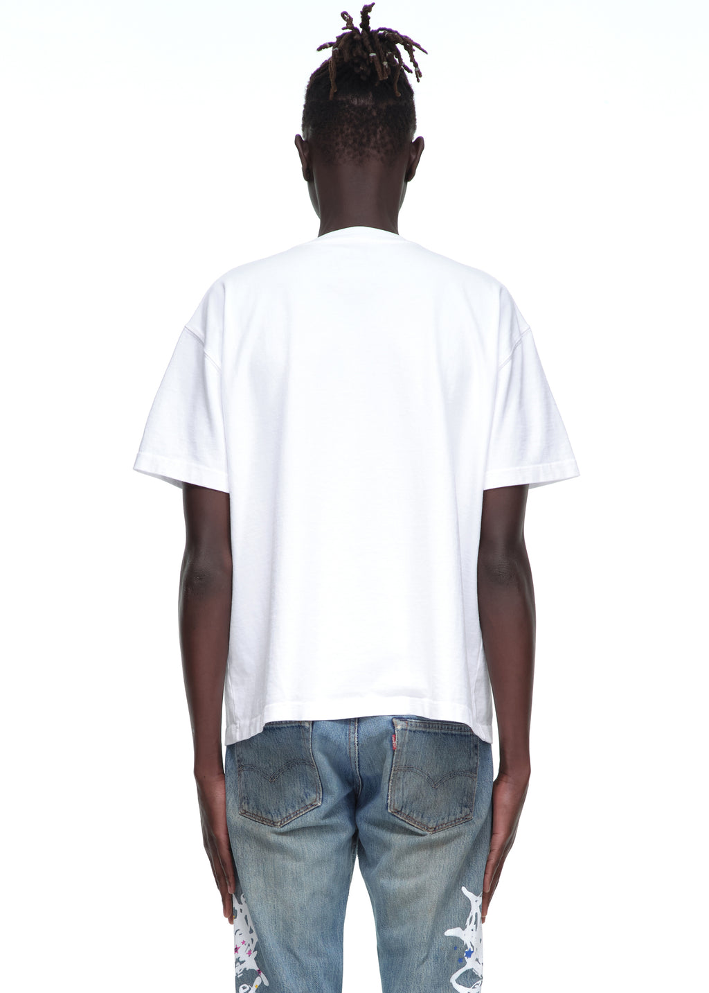 Back view of a male model wearing a plain white 14oz cotton Souvenir Tee with standard fit.